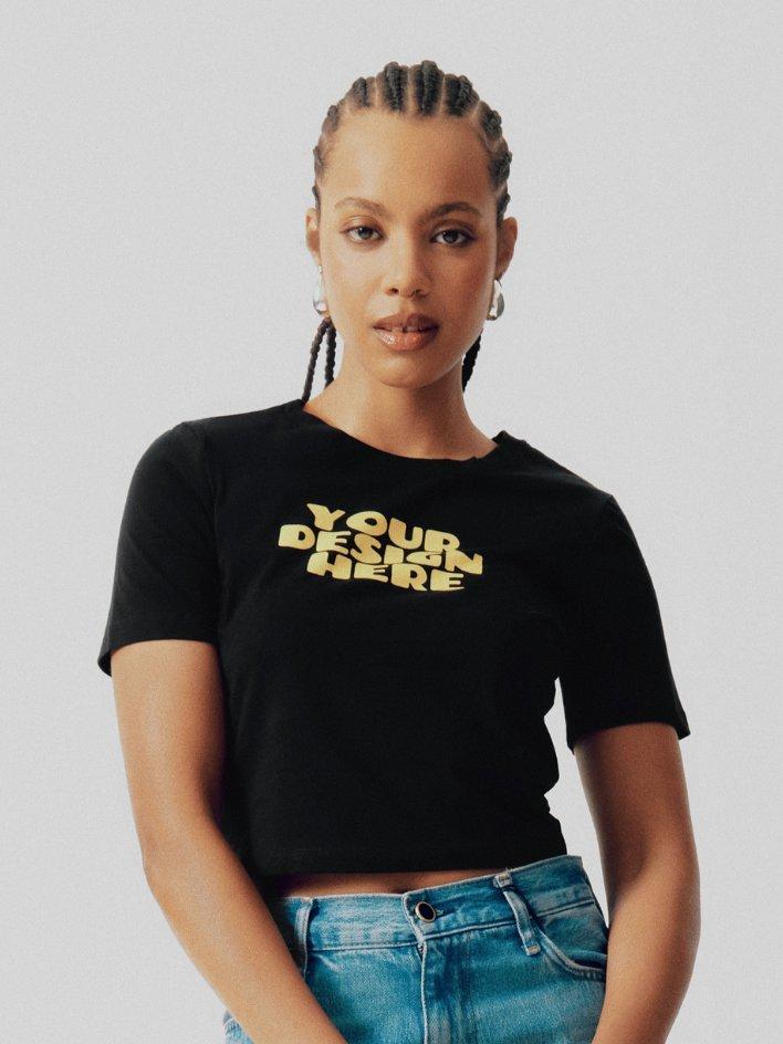 model wearing black cropped tshirt with yellow your design here mockup on it